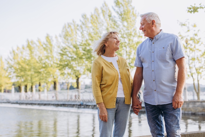 Couple over 50 enjoying a relaxed walk by the water, reflecting senior dating and companionship in Mission Viejo, California.