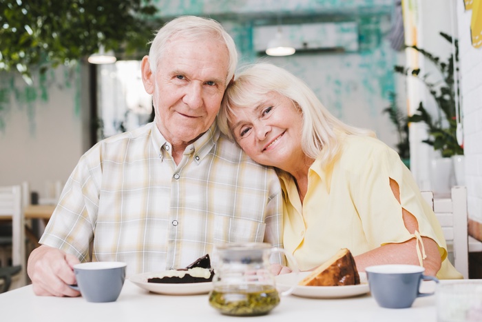 Senior couple enjoying coffee together on a relaxed outdoor date.