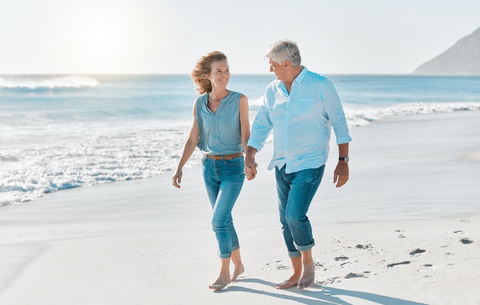 Senior couple enjoying a walk together on the beach in Pompano Beach, Florida