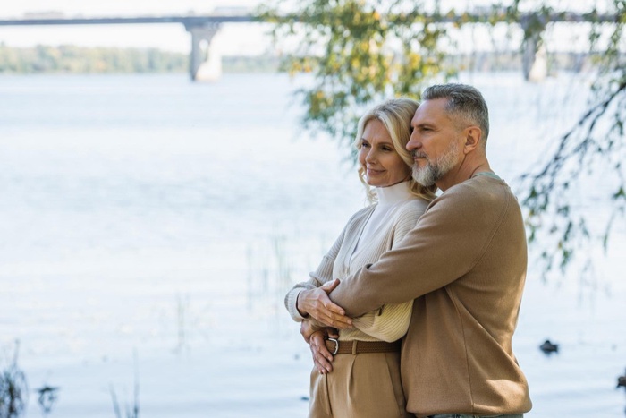 Older couple embracing by the waterfront in Sarnia, Ontario