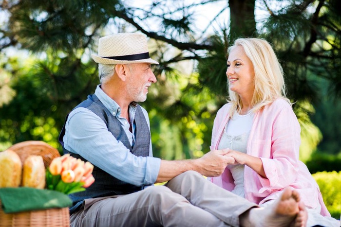 Older couple holding hands during a picnic in Stockton-on-Tees