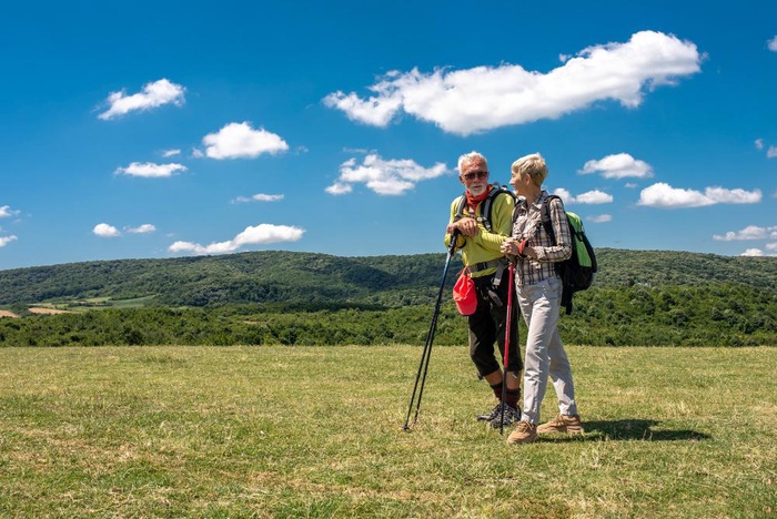 Mature couple hiking across Surrey Hills footpaths