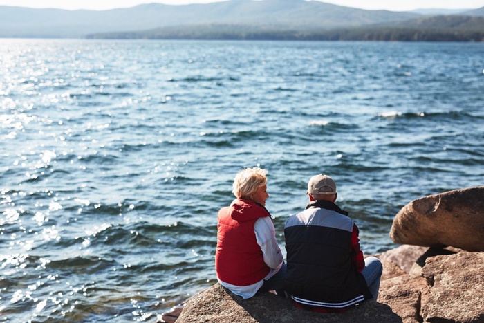 Couple sitting beside the sea