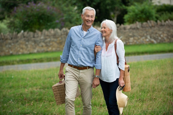 Mature singles walking in an Ellicott City park