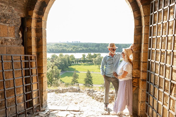 Mature couple looking through a historic arch at Dunfermline Abbey