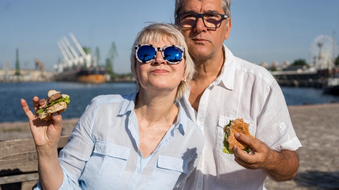 Mature couple sharing a snack beside Ipswich Waterfront