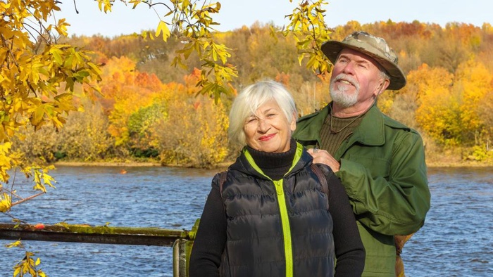 Older couple enjoying an autumn lakeside view in St. Albert, Alberta