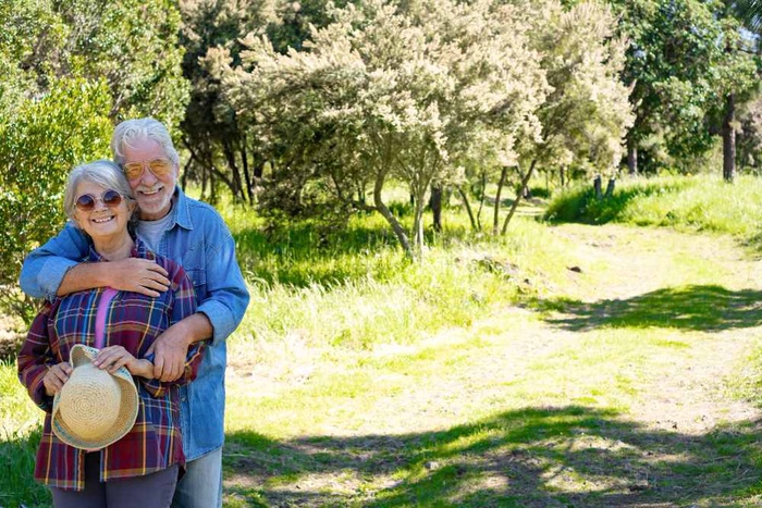 Senior couple embracing on a sunny walking trail in West Valley City, Utah