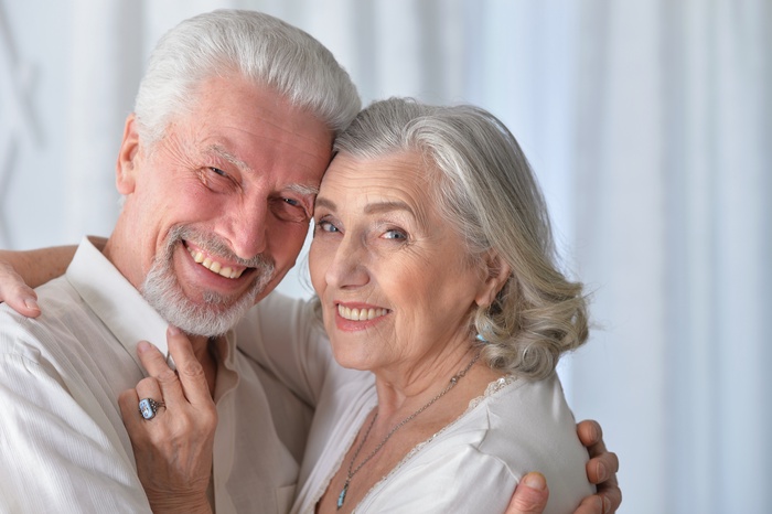 Smiling senior couple embracing and enjoying a warm moment together at home.