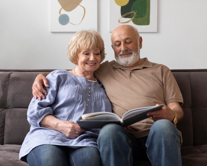 Older couple sharing photographs and talking about their personal histories