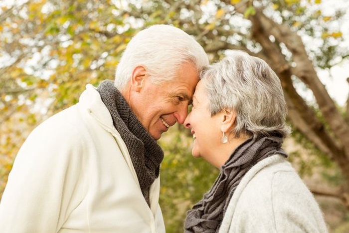 Senior couple sharing an affectionate moment outdoors in autumn