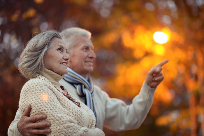 A smiling older couple enjoying an evening out together