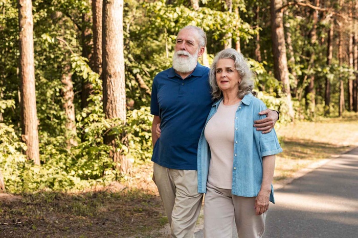 Couple over 50 walking through a garden in Spring Hill, Florida