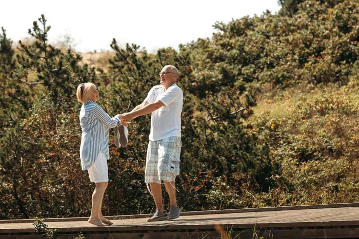 Older couple holding hands on a wooded trail in Athens, Georgia