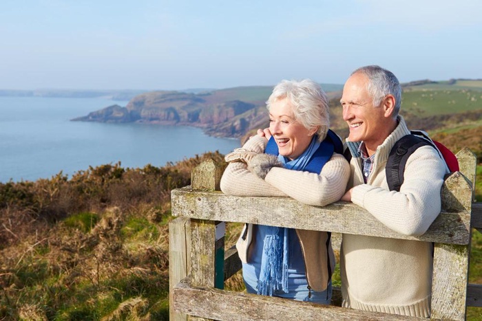 Older couple enjoying a scenic coastal view during an outdoor trip from Perth, Scotland