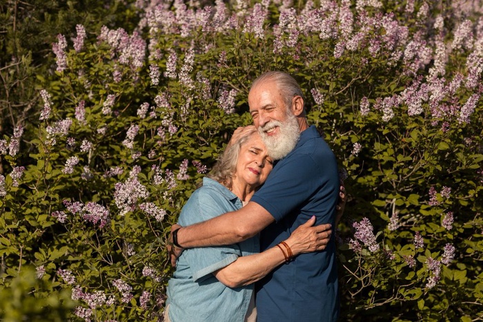 Mature couple embracing in a Hattiesburg garden