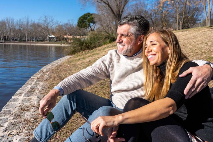 Senior couple relaxing together by a lakeside in Lewisville, Texas