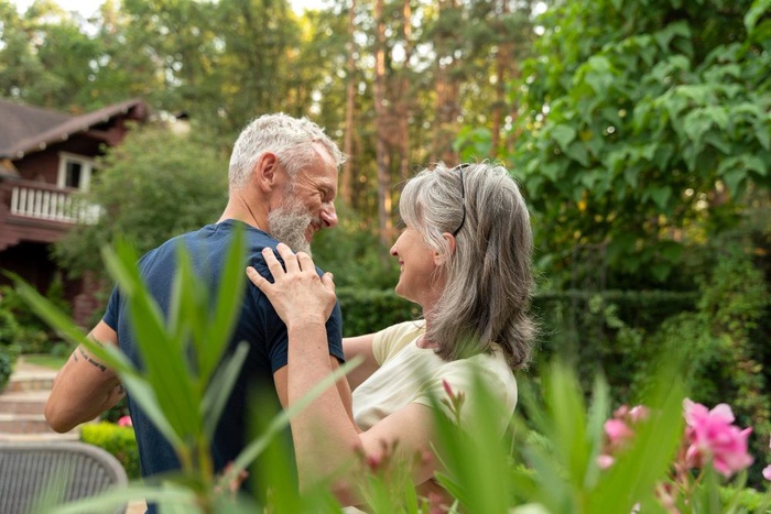 Older couple sharing a warm moment in a garden in Cranbourne North