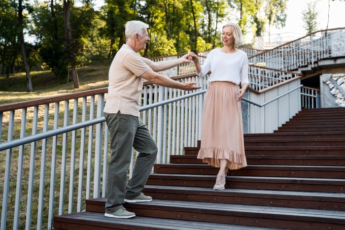 Couple over 50 walking park stairs in Courtenay