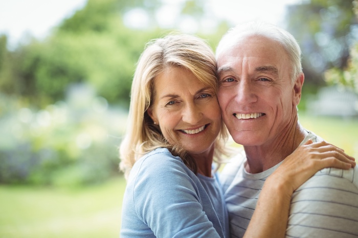 Senior couple enjoying time together outdoors in a green park in Saanich, British Columbia.