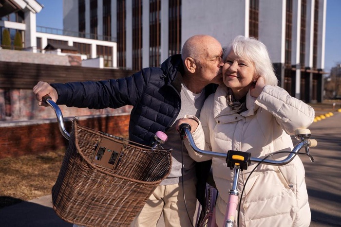 Senior couple with bicycles sharing an affectionate moment in Greeley, Colorado