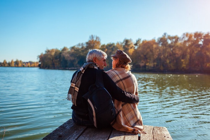 Older couple sitting together by a lake in Bloomington, Minnesota