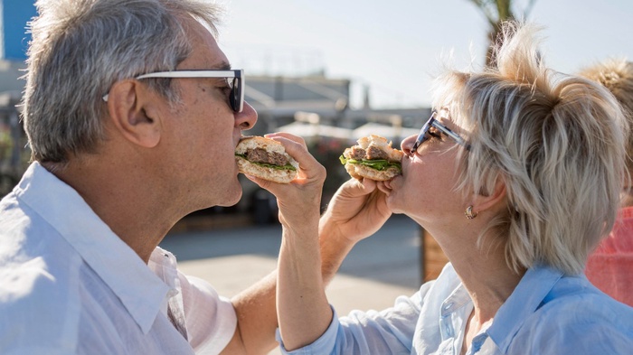 Senior couple enjoying food beside Torquay Harbour