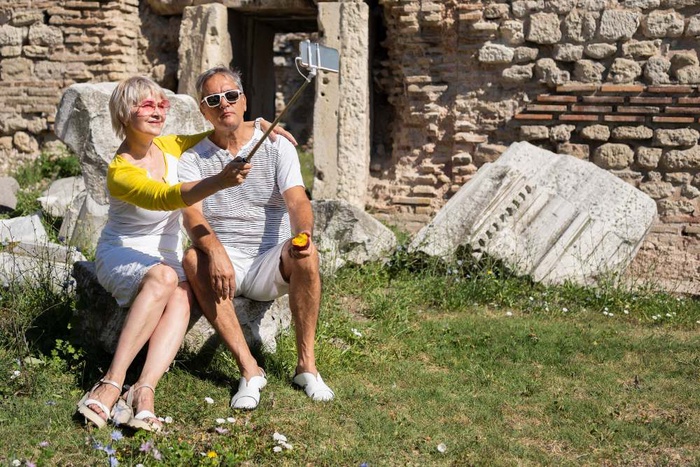 Mature couple taking a selfie near historic ruins