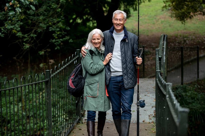 Dover singles over 50 walking along a scenic trail bridge