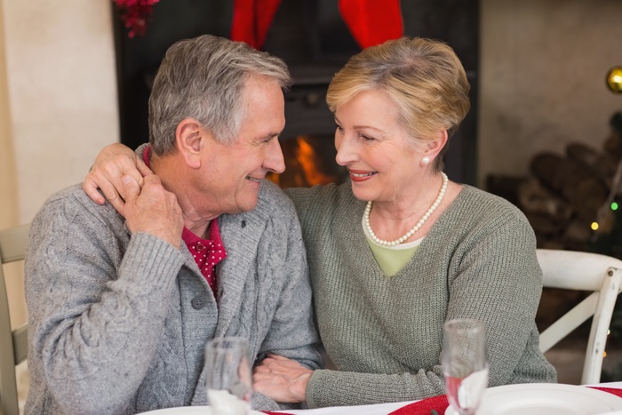 Senior couple sharing a warm moment over dinner