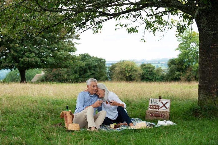 Older couple having a picnic in the countryside near Redhill, England