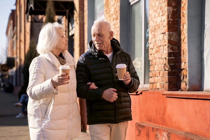Mature couple enjoying morning coffee walk in downtown Gulfport