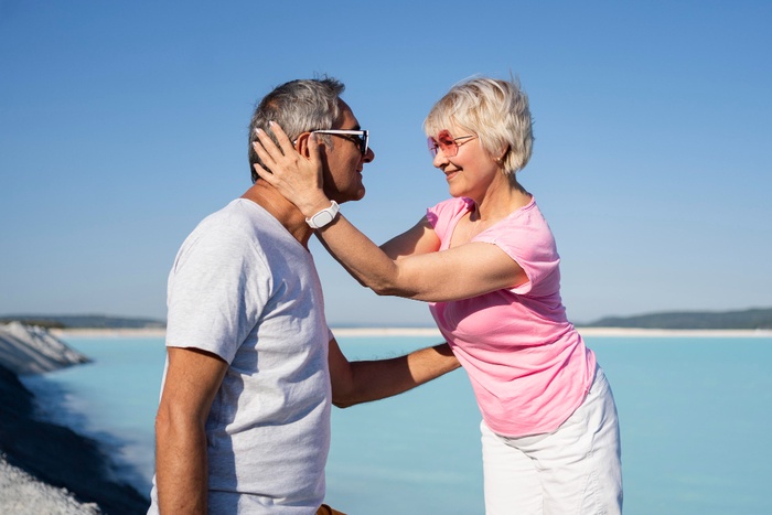 Senior couple sharing an affectionate moment by the water