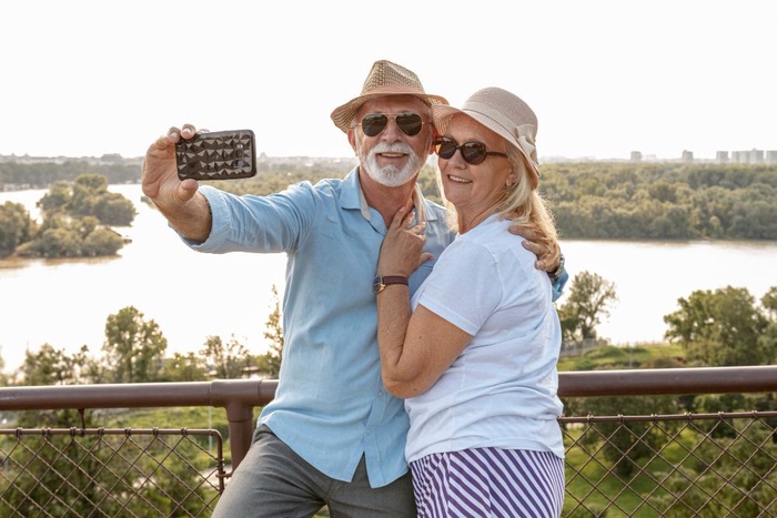Older couple taking a selfie by the river in Saint Joseph, Missouri