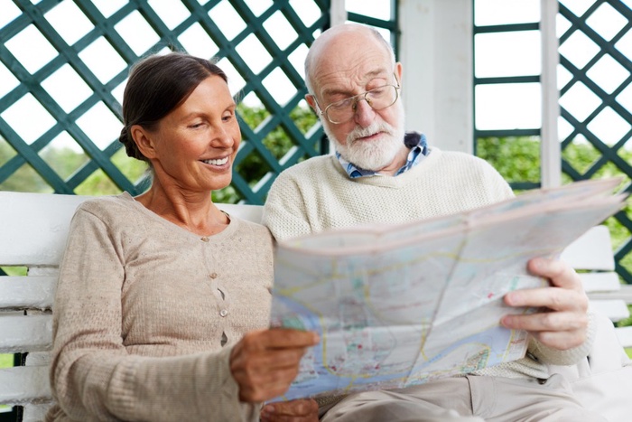 Mature couple looking at a map together while planning a day out