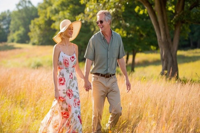 Senior couple enjoying a peaceful walk together through a sunny park meadow in New Jersey.