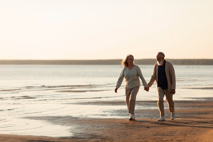 Mature couple walking along the Lough Neagh shoreline near Oxford Island