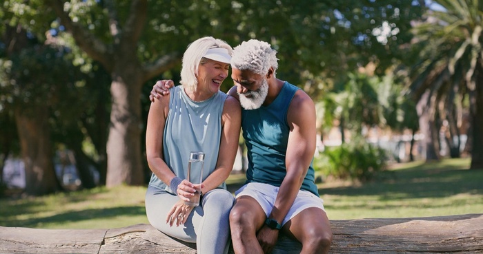 Active senior couple relaxing together in a sunny park