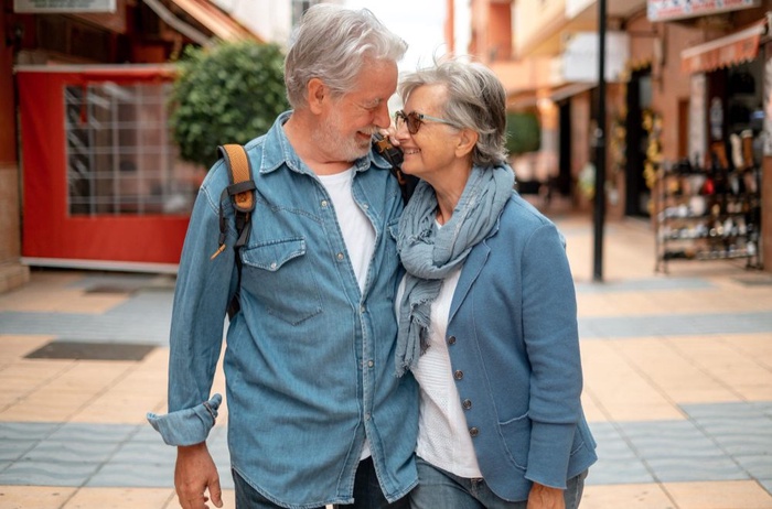 Senior couple walking closely together through a pedestrian area in Alachua, Florida