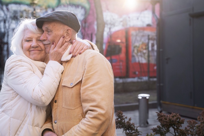 Older couple sharing a warm moment during a relaxed public outing