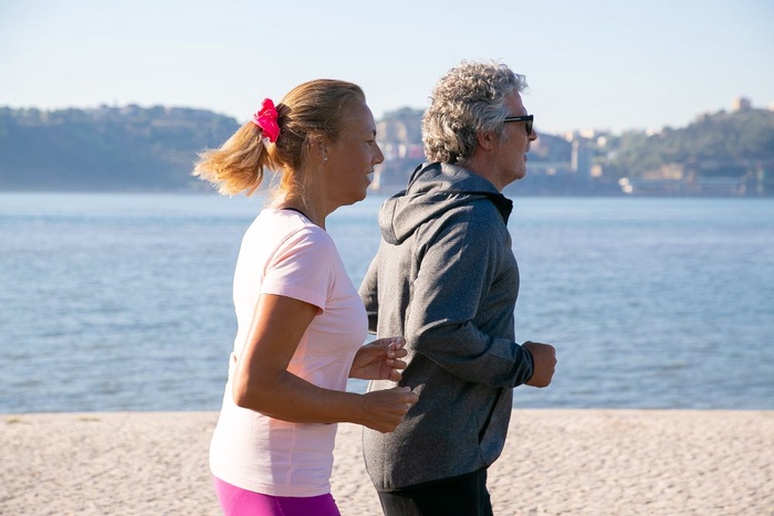 Mature couple walking along a Pearl Harbor park