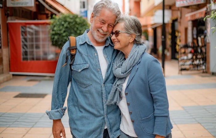 Older couple walking closely together on a street in Cowbridge, Wales