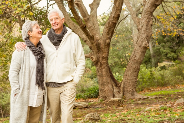 Senior couple enjoying a walk together in a leafy park