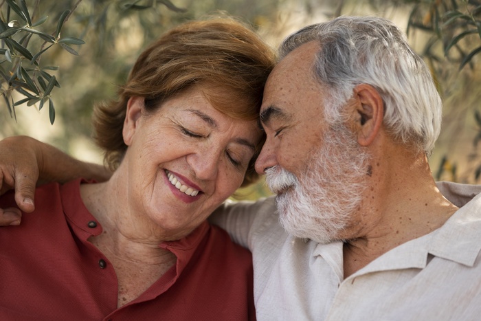 Mature couple sharing a warm, affectionate moment outdoors