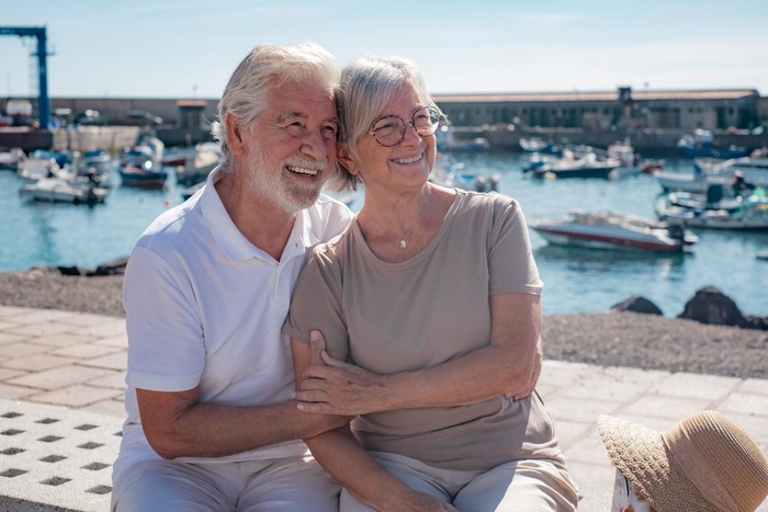 Older couple relaxing by a marina in Warwick, Rhode Island