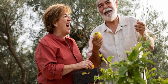 Couple over 50 sharing a laugh on an outdoor date