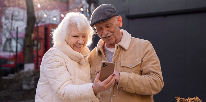 Older couple looking at a phone together