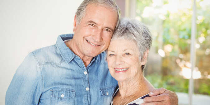 over 70 senior couple embracing