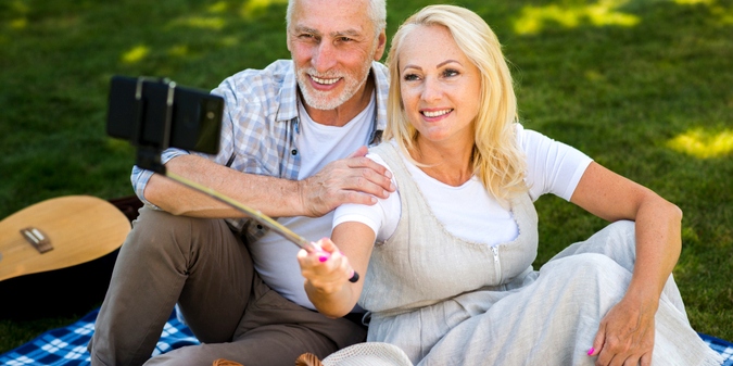Mature couple taking a picnic selfie