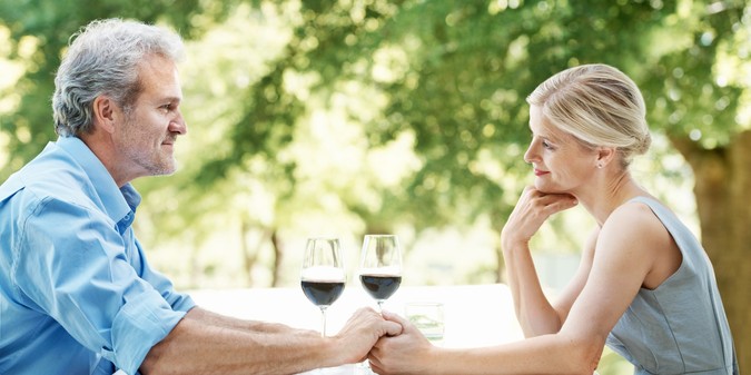 Mature couple holding hands on an outdoor date